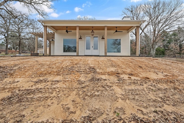 back of property featuring french doors, a chimney, and ceiling fan