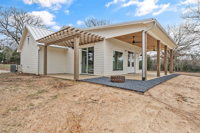 back of house with an outdoor fire pit, a patio, ceiling fan, metal roof, and central air condition unit