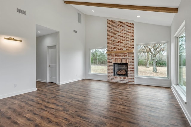 unfurnished living room with dark wood finished floors, a brick fireplace, visible vents, and beamed ceiling