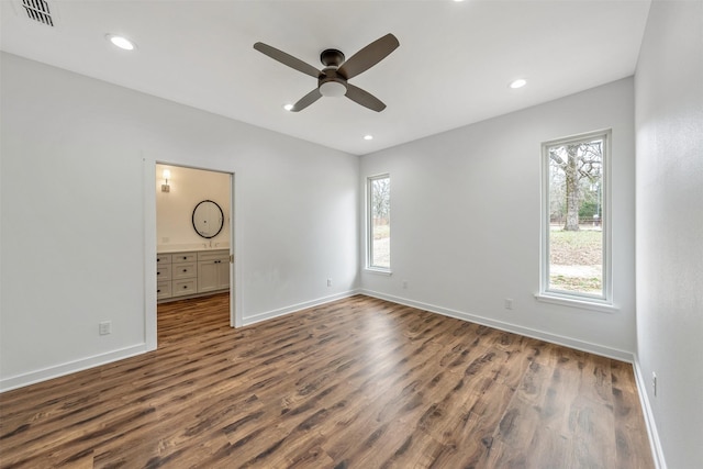 unfurnished bedroom with visible vents, baseboards, dark wood-style flooring, and recessed lighting