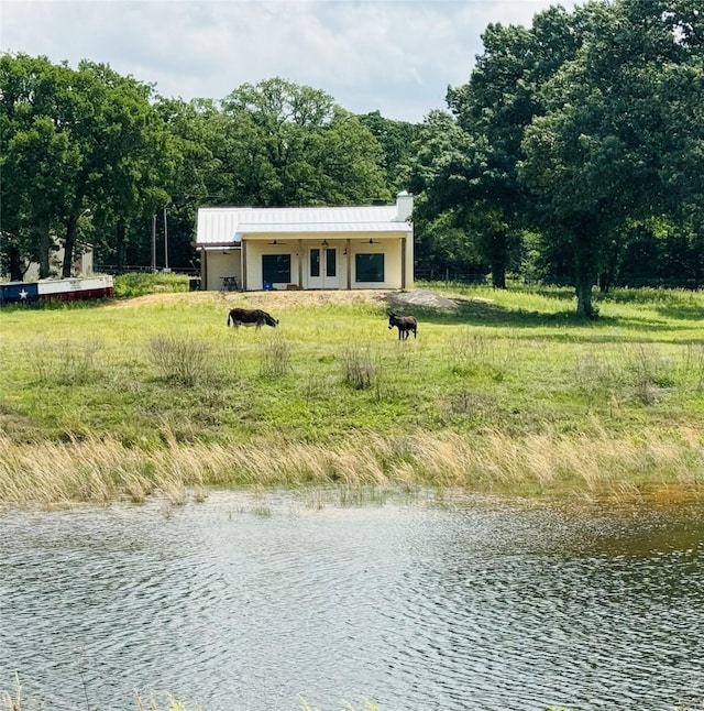 exterior space featuring a chimney and a water view