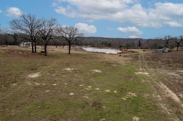 view of yard featuring a rural view and a water view