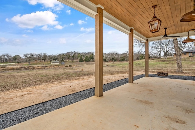 view of patio / terrace featuring a ceiling fan and a rural view