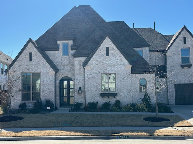 2325 Miranda Ln, Rockwall, TX 75087 - french provincial home featuring roof with shingles, french doors, and brick siding