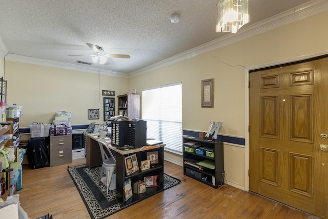 office space featuring visible vents, crown molding, and wood finished floors