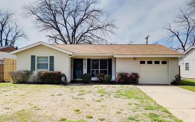 ranch-style house featuring a front lawn, driveway, an attached garage, and fence