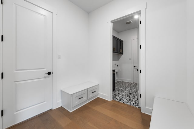 mudroom featuring wood finished floors, visible vents, and baseboards