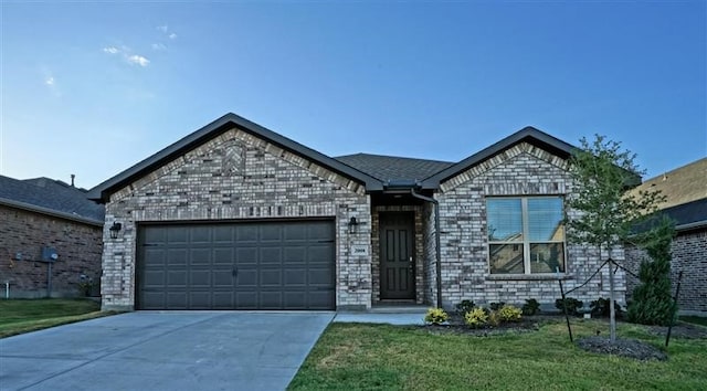 ranch-style home featuring a garage, brick siding, driveway, and a front lawn