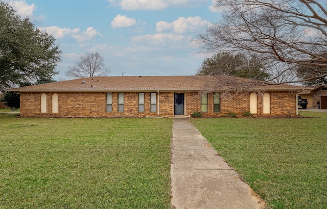 single story home featuring brick siding and a front yard