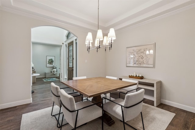 8 Center Ct, Heath, TX 75032 - dining area featuring a raised ceiling, a chandelier, dark wood-type flooring, arched walkways, and crown molding