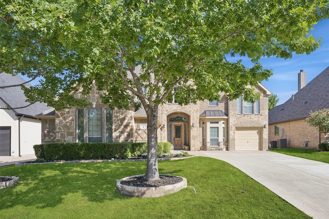 8 Center Ct, Heath, TX 75032 - view of front of property with concrete driveway, stone siding, a front lawn, and an attached garage