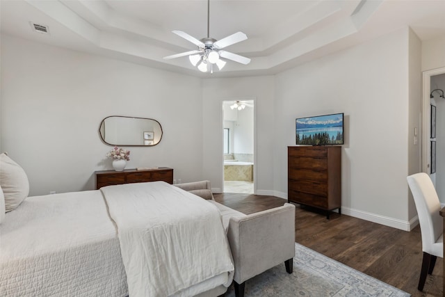 8 Center Ct, Heath, TX 75032 - bedroom featuring a tray ceiling, wood finished floors, ensuite bath, and a ceiling fan