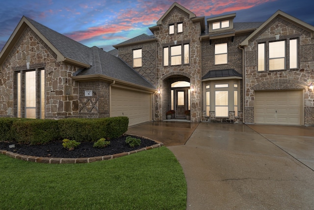 8 Center Ct, Heath, TX 75032 - view of front of home featuring stone siding, driveway, and an attached garage