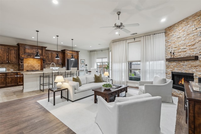 8 Center Ct, Heath, TX 75032 - living area with a ceiling fan, recessed lighting, light wood-style floors, and a stone fireplace