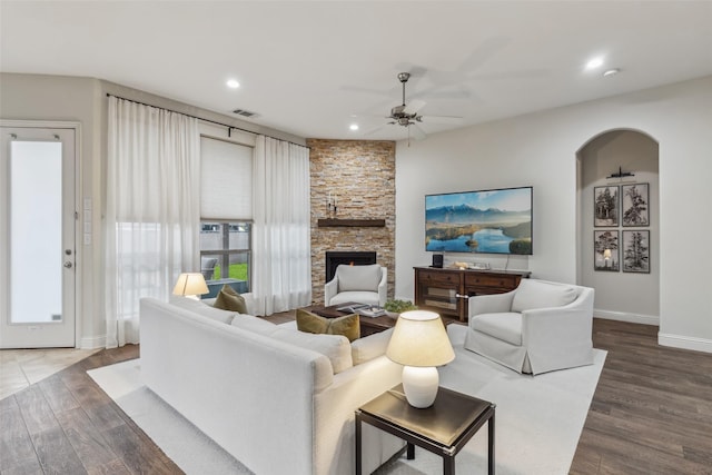 8 Center Ct, Heath, TX 75032 - living room with a ceiling fan, wood finished floors, recessed lighting, a fireplace, and arched walkways