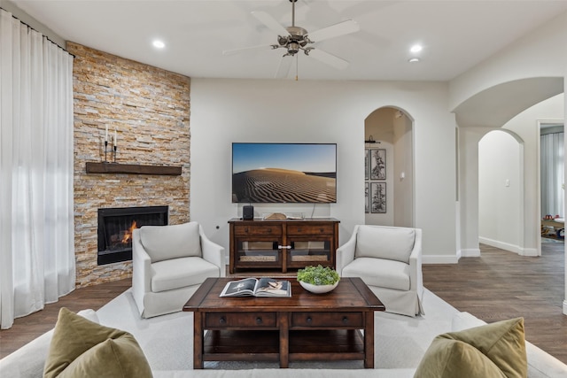 8 Center Ct, Heath, TX 75032 - living area featuring arched walkways, wood finished floors, a ceiling fan, a fireplace, and recessed lighting