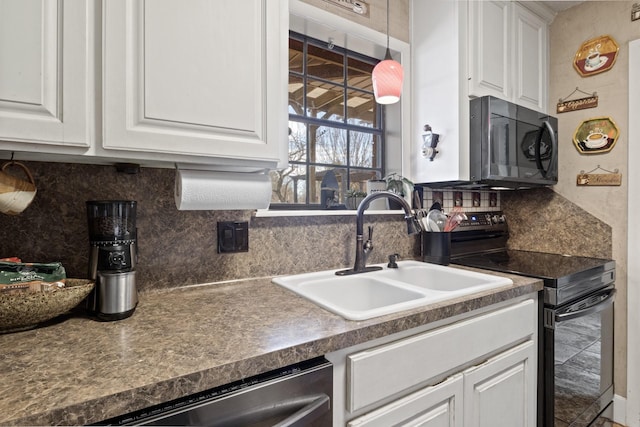 kitchen with dark countertops, a sink, and electric range