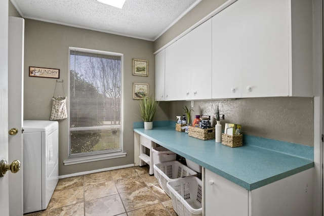 kitchen with a textured ceiling, light countertops, washer / clothes dryer, and white cabinetry