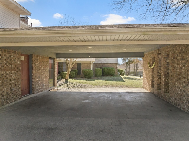 view of parking with an attached carport and driveway