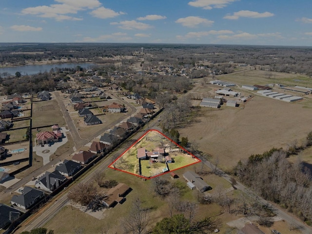 birds eye view of property with a residential view and a water view