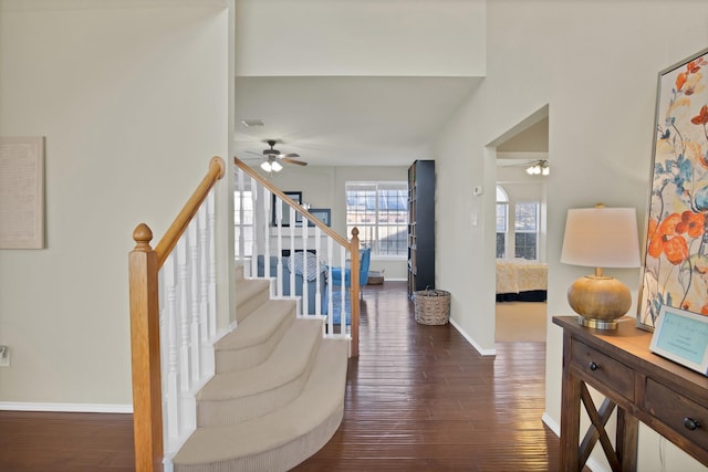 entrance foyer featuring visible vents, dark wood-type flooring, a ceiling fan, baseboards, and stairs