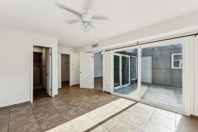 unfurnished bedroom featuring access to exterior, visible vents, ceiling fan, and baseboards