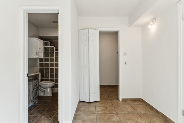 bathroom featuring tile patterned flooring, visible vents, and toilet