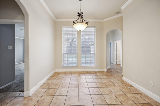 unfurnished dining area featuring arched walkways, light tile patterned floors, ornamental molding, and baseboards