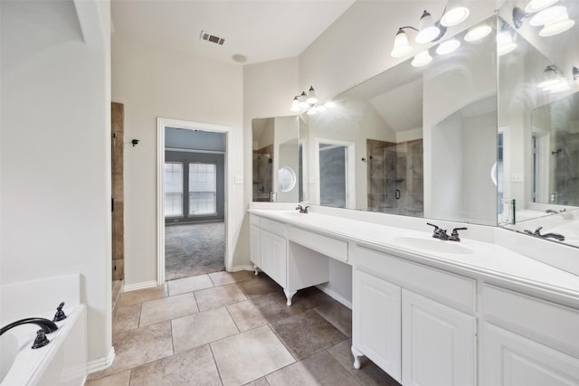 full bath featuring double vanity, a stall shower, and a sink