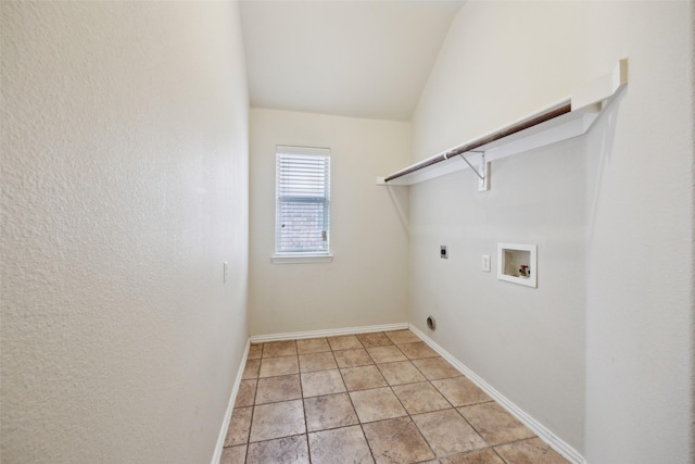 laundry area with light tile patterned floors, hookup for a washing machine, hookup for an electric dryer, laundry area, and baseboards