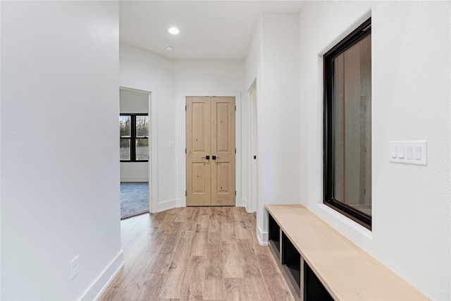 interior space featuring light wood-type flooring, baseboards, and recessed lighting