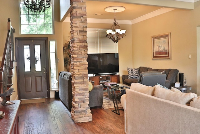 living area featuring ornamental molding, dark wood-style flooring, a notable chandelier, and decorative columns