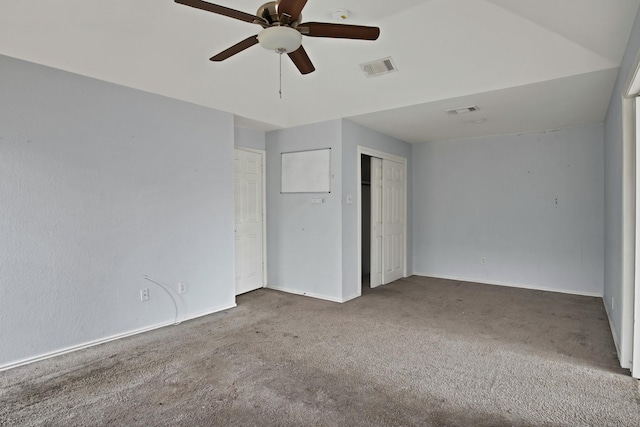 unfurnished bedroom with carpet floors, baseboards, visible vents, and ceiling fan