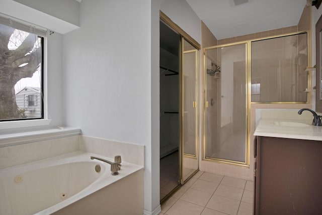 bathroom featuring visible vents, vanity, a jetted tub, a shower stall, and tile patterned floors