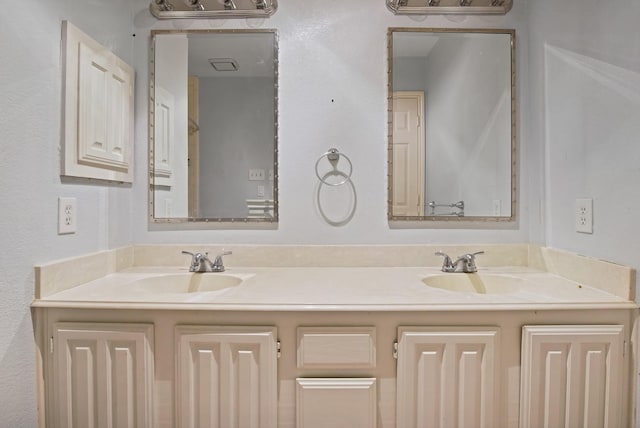 full bath featuring a sink and double vanity