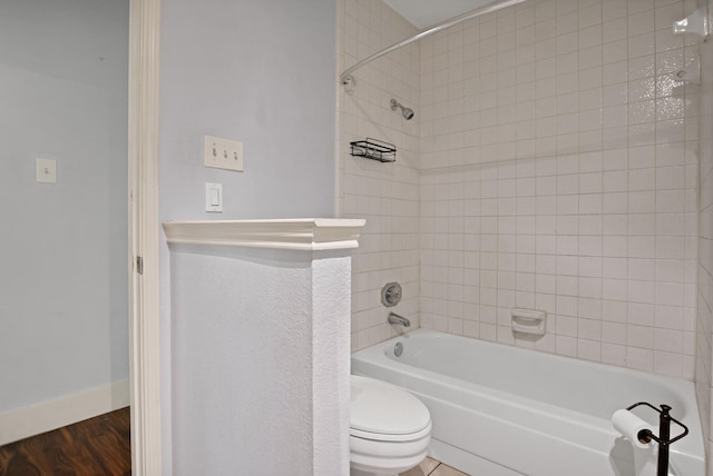 full bath featuring shower / bath combination, wood finished floors, toilet, and baseboards