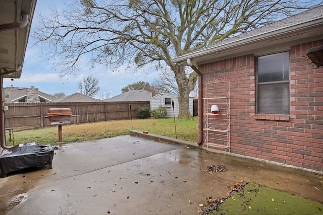 view of patio / terrace featuring a shed, an outdoor structure, and a fenced backyard