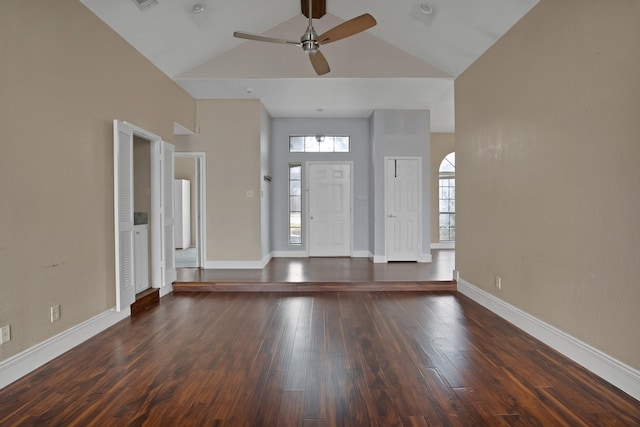 foyer entrance with baseboards, visible vents, ceiling fan, dark wood-type flooring, and high vaulted ceiling