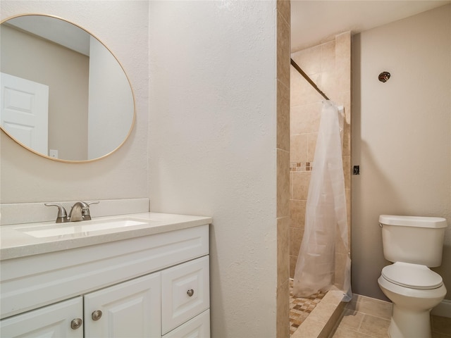 full bath with a stall shower, tile patterned flooring, vanity, and toilet