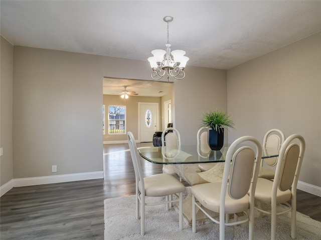 dining room featuring a notable chandelier, wood finished floors, and baseboards