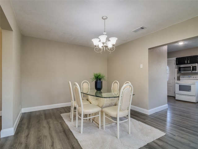 dining room with a chandelier, visible vents, dark wood-type flooring, and baseboards