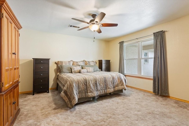 bedroom featuring light carpet, ceiling fan, visible vents, and baseboards