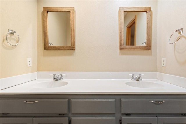 bathroom featuring double vanity and a sink