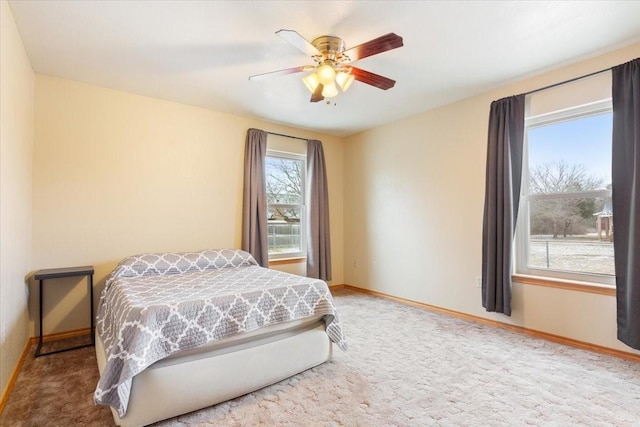 bedroom with carpet, a ceiling fan, and baseboards