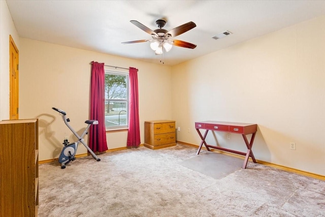 interior space with baseboards, ceiling fan, visible vents, and light colored carpet