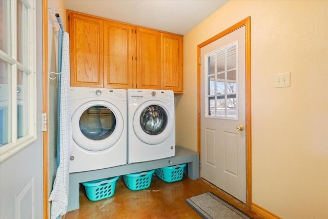 laundry area with washing machine and clothes dryer and cabinet space