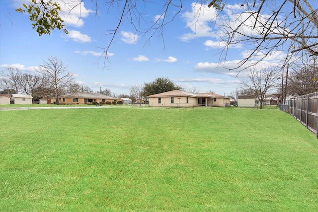 view of yard featuring a residential view and fence