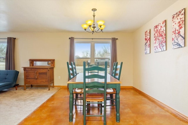 dining room with a notable chandelier, baseboards, and a wealth of natural light