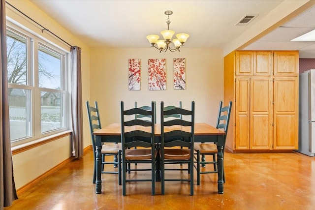 dining area with visible vents, a notable chandelier, finished concrete flooring, and baseboards