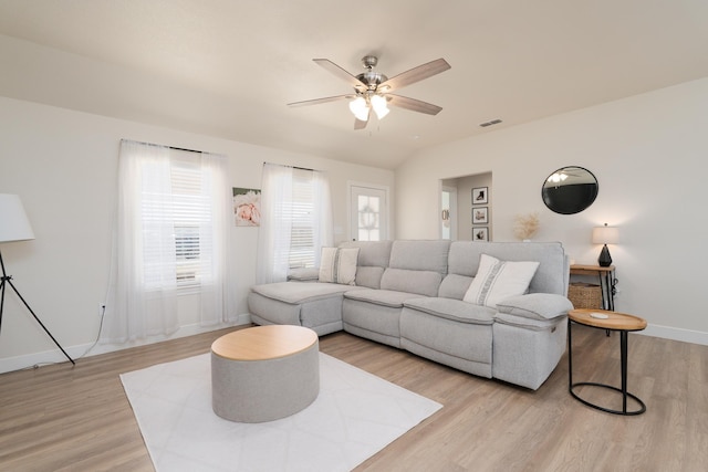 living area with light wood-style floors, visible vents, and a wealth of natural light